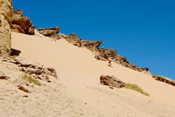 Pioneering sand boarding on a huge dune near Haql.
